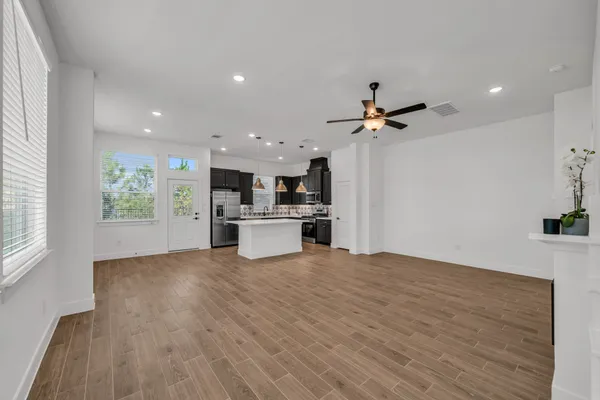 a view of kitchen with sink and refrigerator