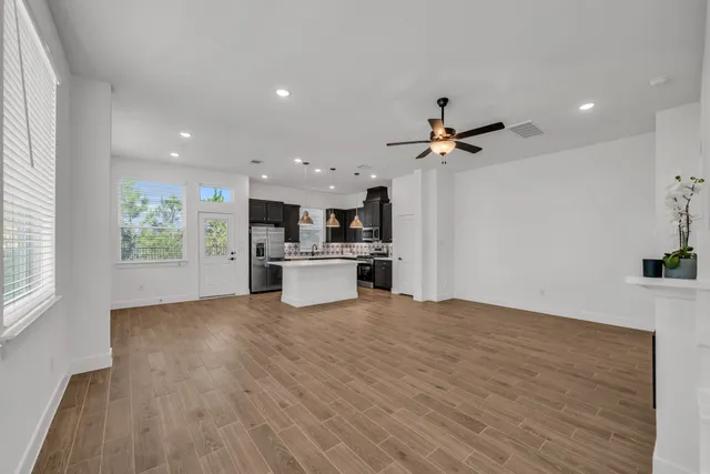 a view of kitchen with sink and refrigerator