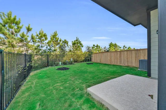 a view of a backyard with wooden fence