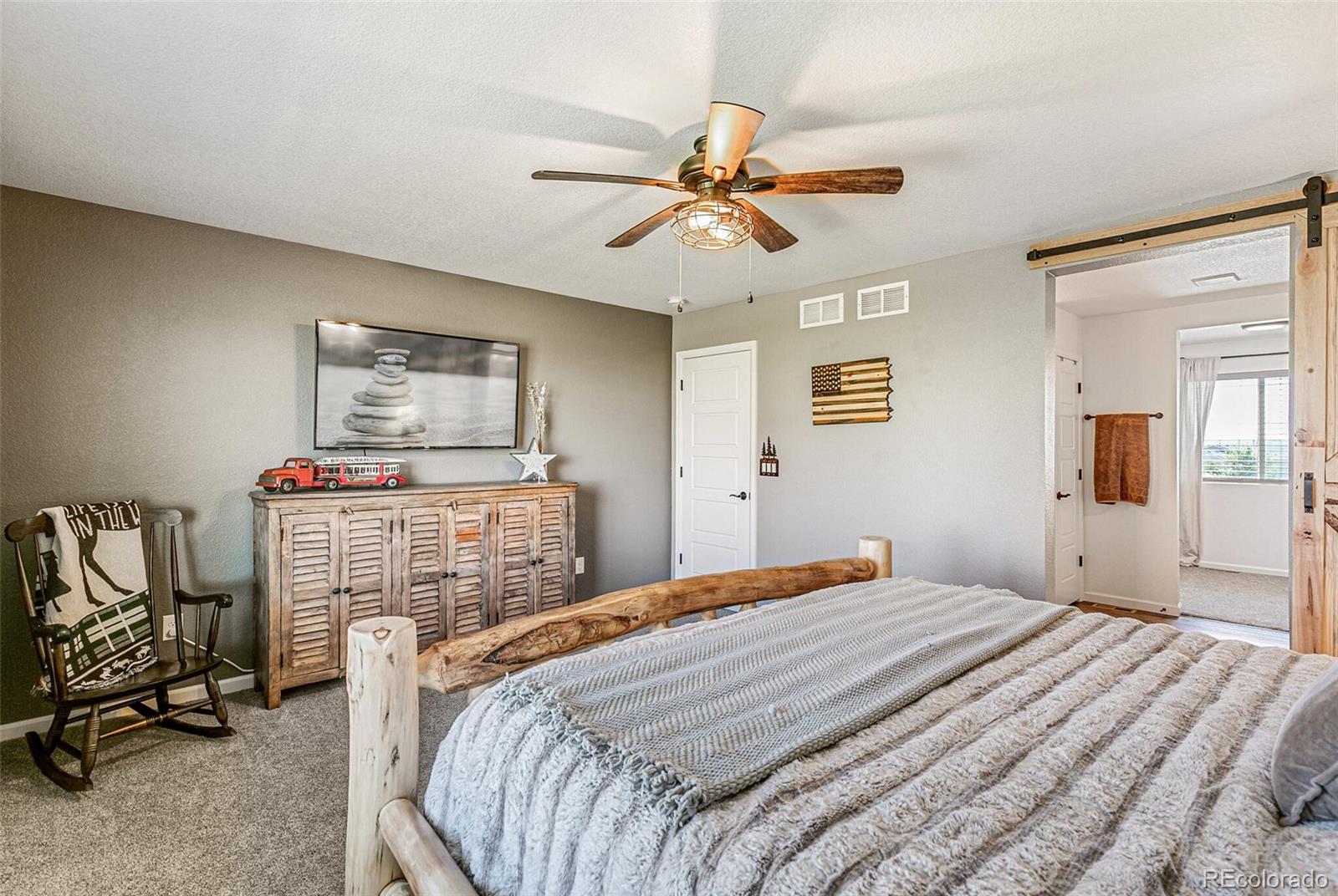 42891 Hawktree Circle Elizabeth, CO 80107 - Photo 20 of 39 a bedroom with a bed and wooden floor