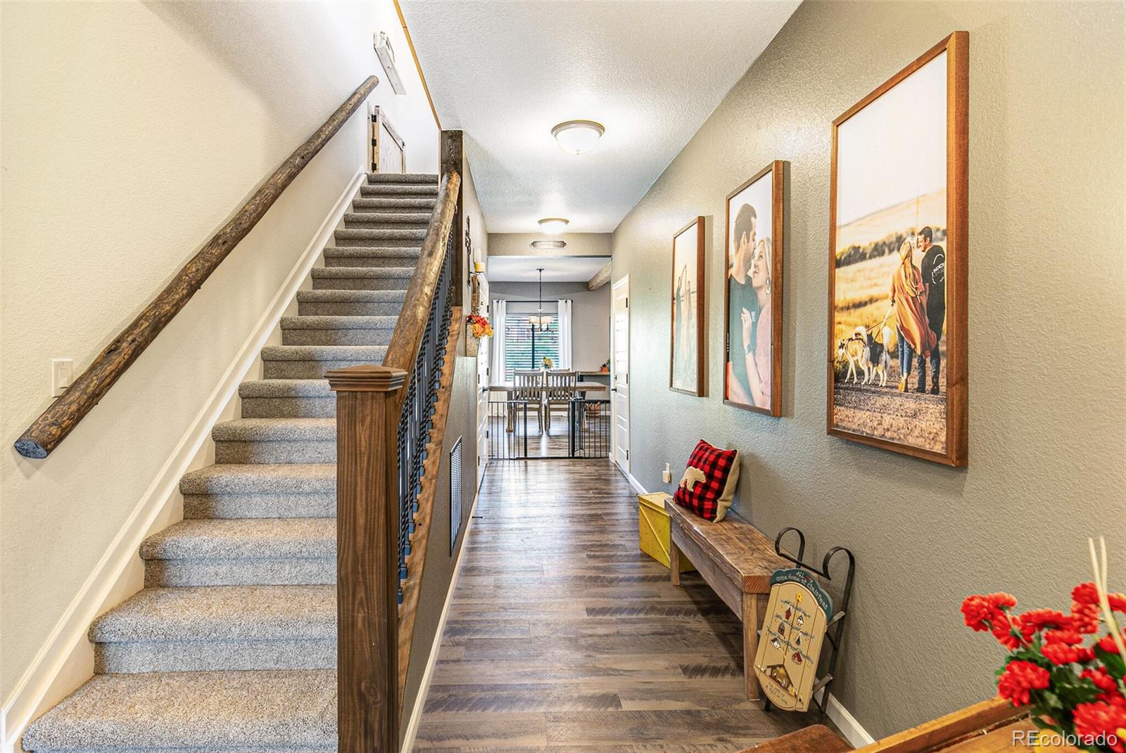 42891 Hawktree Circle Elizabeth, CO 80107 - Photo 2 of 39 a hallway with wooden floor and stairs