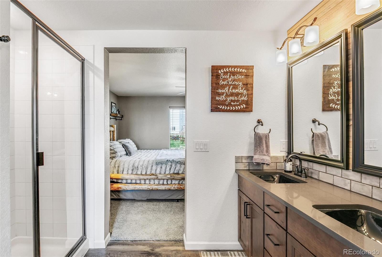 42891 Hawktree Circle Elizabeth, CO 80107 - Photo 21 of 39 a en suite bathroom with a sink and a mirror