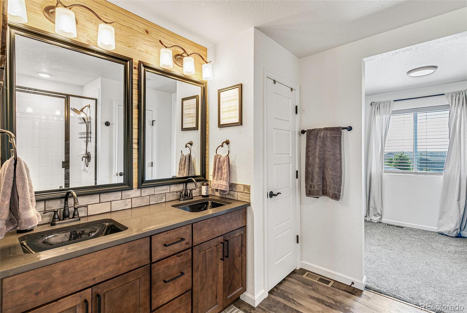 42891 Hawktree Circle Elizabeth, CO 80107 - Photo 22 of 39 a bathroom with a sink and a mirror