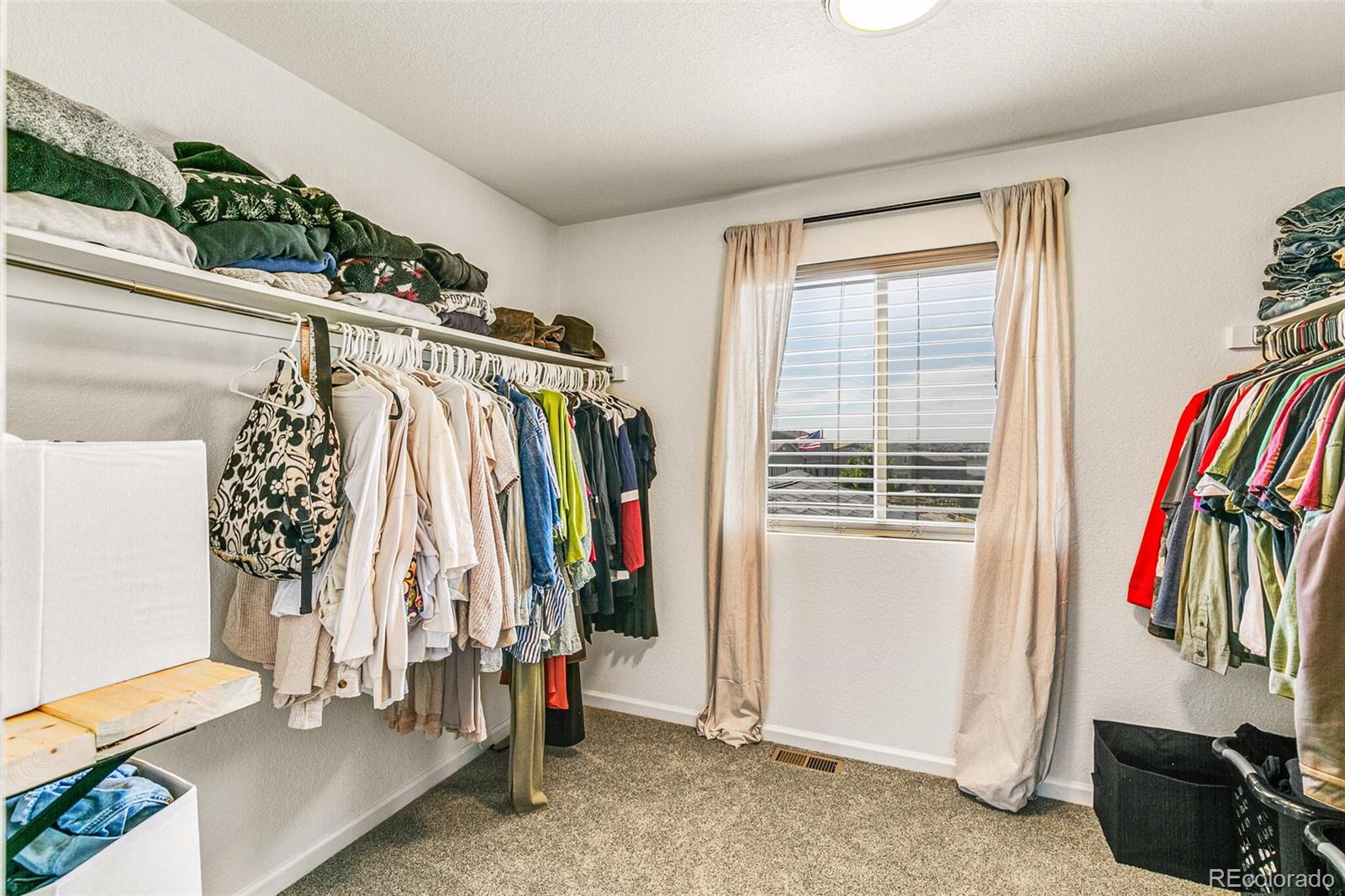 42891 Hawktree Circle Elizabeth, CO 80107 - Photo 24 of 39 a view of walk in closet with clothes and shoes