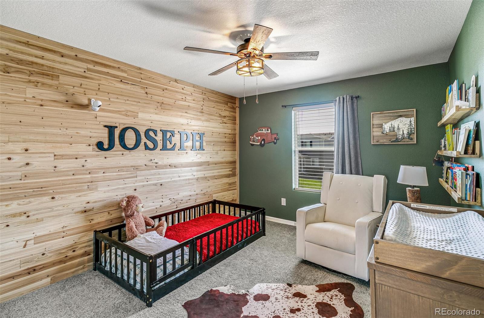 42891 Hawktree Circle Elizabeth, CO 80107 - Photo 27 of 39 a bedroom with furniture and a ceiling fan