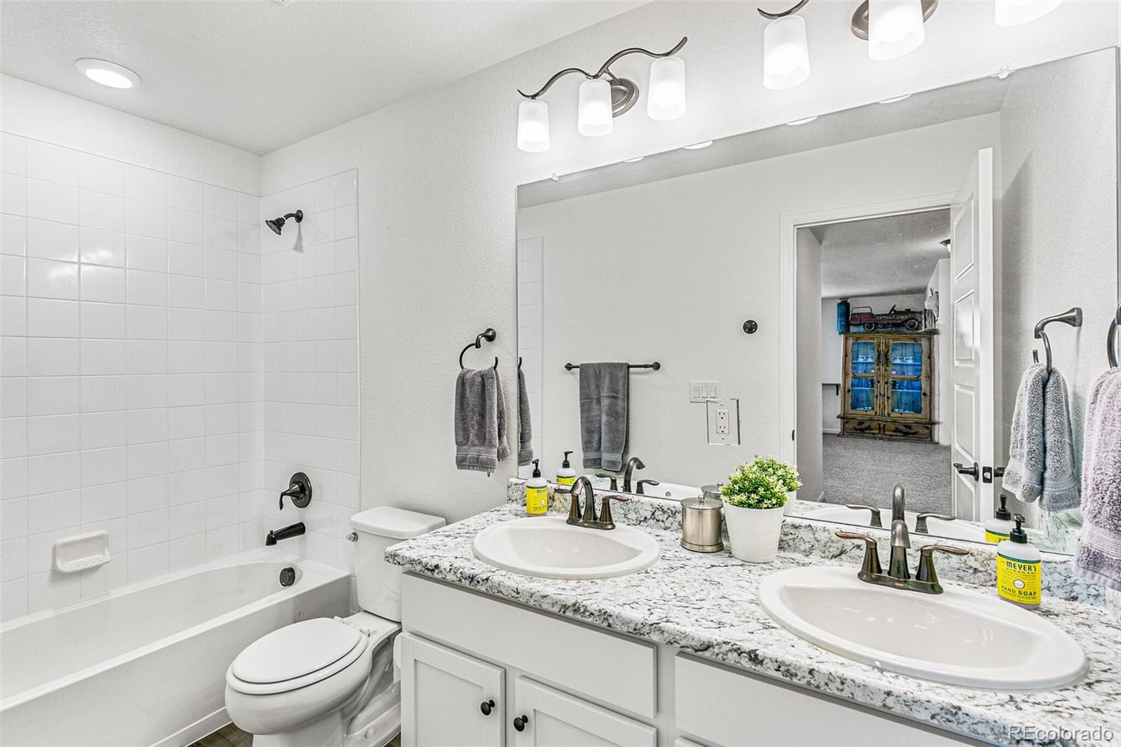 42891 Hawktree Circle Elizabeth, CO 80107 - Photo 28 of 39 a bathroom with a granite countertop sink a toilet and shower