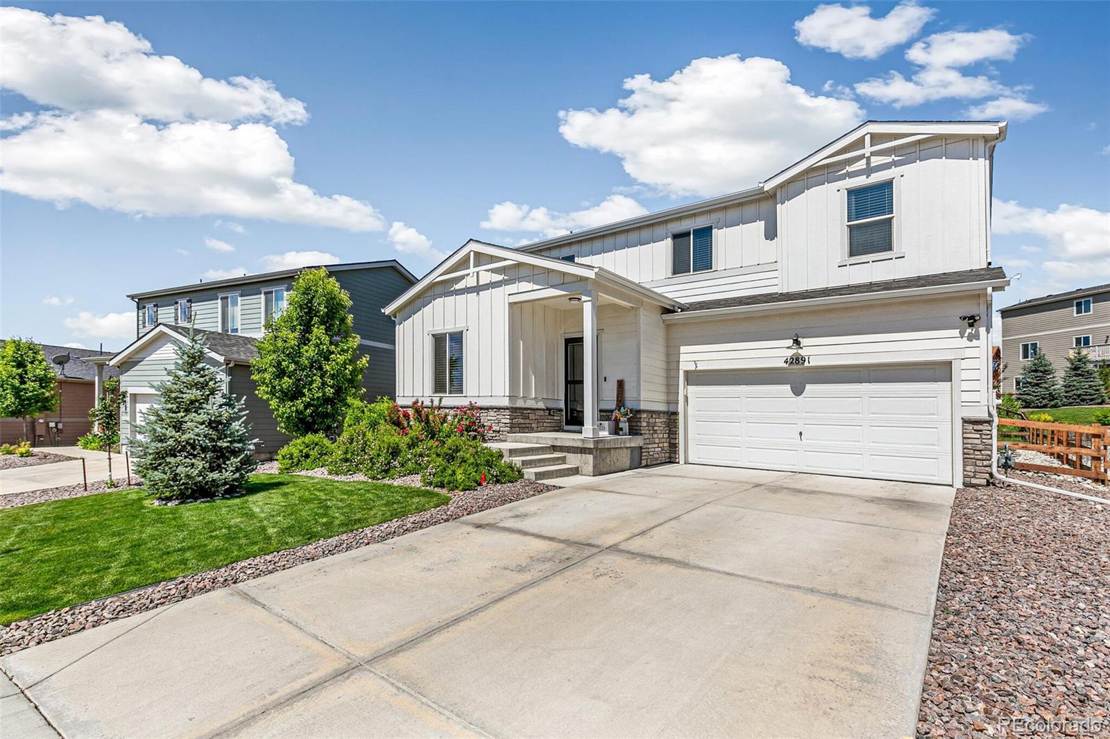 42891 Hawktree Circle Elizabeth, CO 80107 - Photo 32 of 39 a front view of a house with a yard and garage