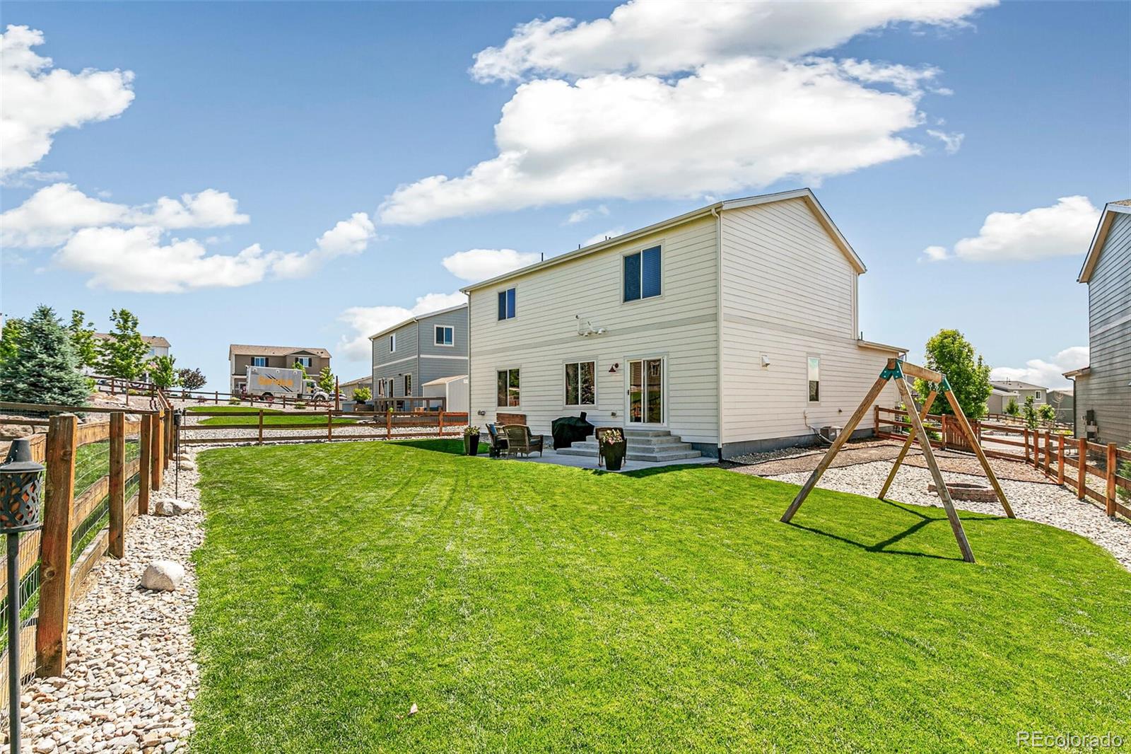 42891 Hawktree Circle Elizabeth, CO 80107 - Photo 33 of 39 a view of a house with a backyard porch and sitting area