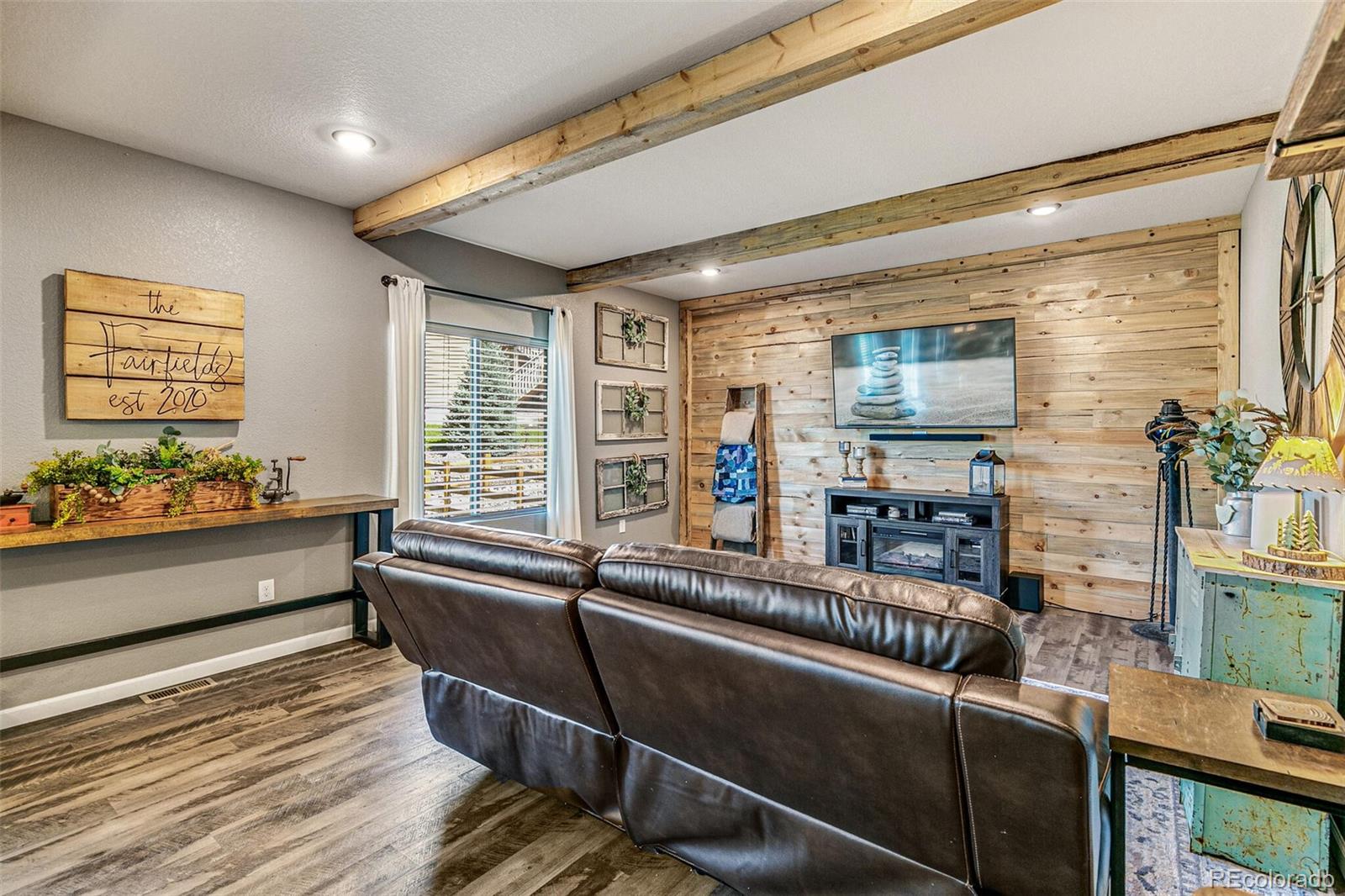 42891 Hawktree Circle Elizabeth, CO 80107 - Photo 5 of 39 a living room with furniture and a flat screen tv