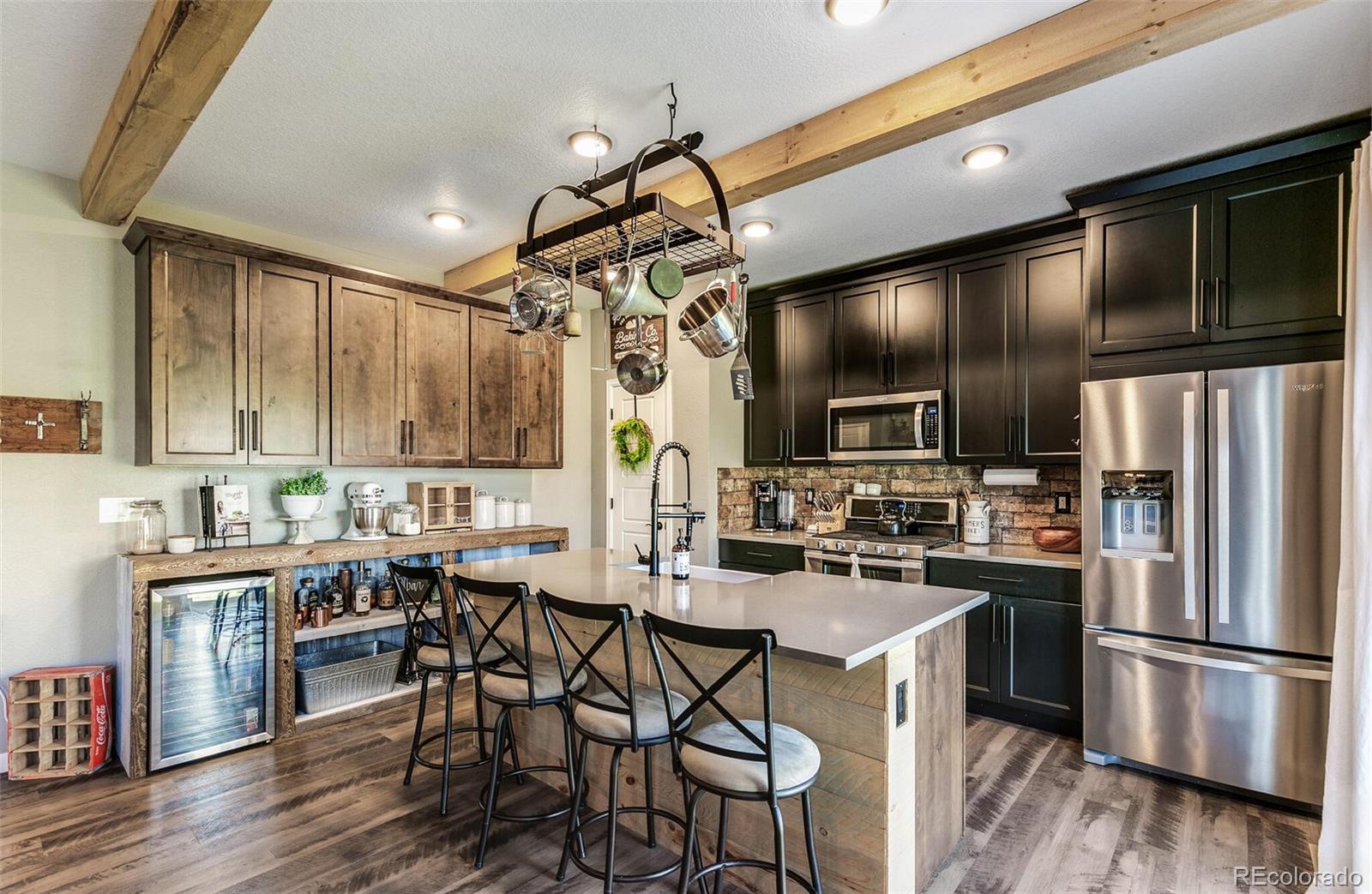 42891 Hawktree Circle Elizabeth, CO 80107 - Photo 10 of 39 a kitchen with kitchen island a large counter top space appliances and cabinets