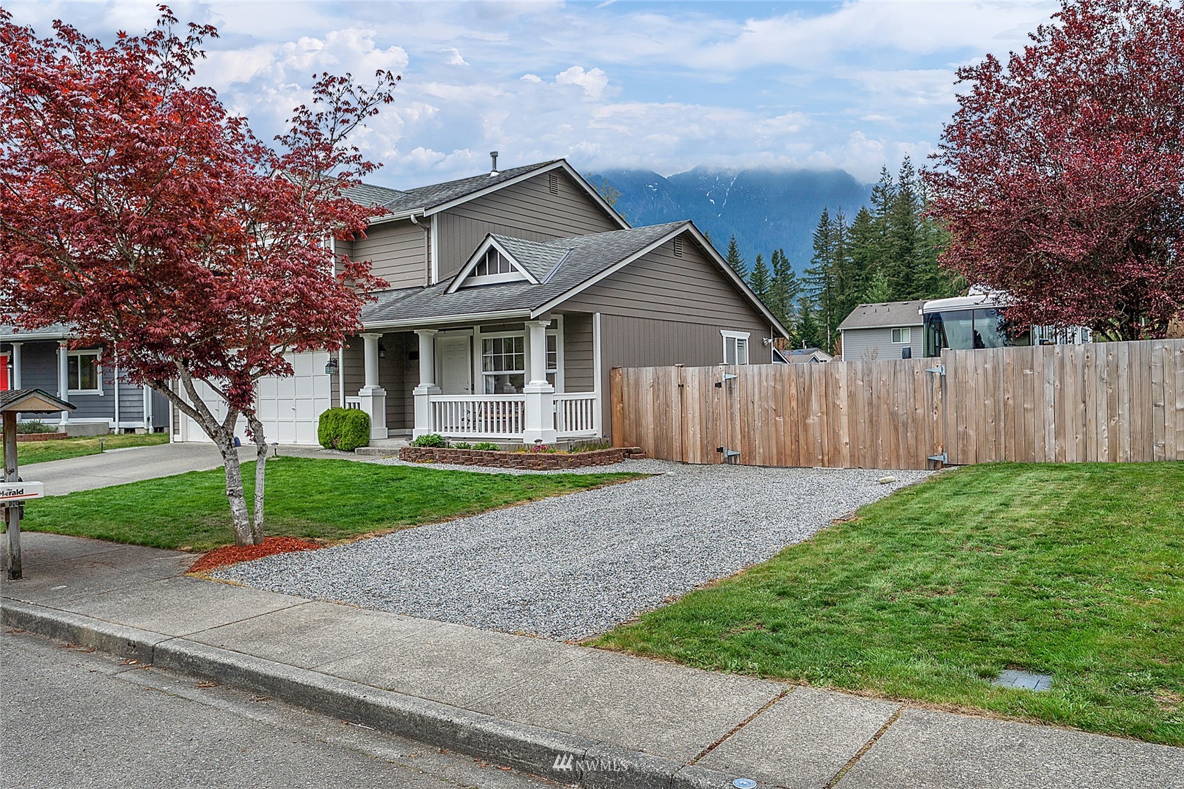 234 17th Street Gold Bar, WA 98251 - Photo 23 of 25 a front view of a house with a yard and garage