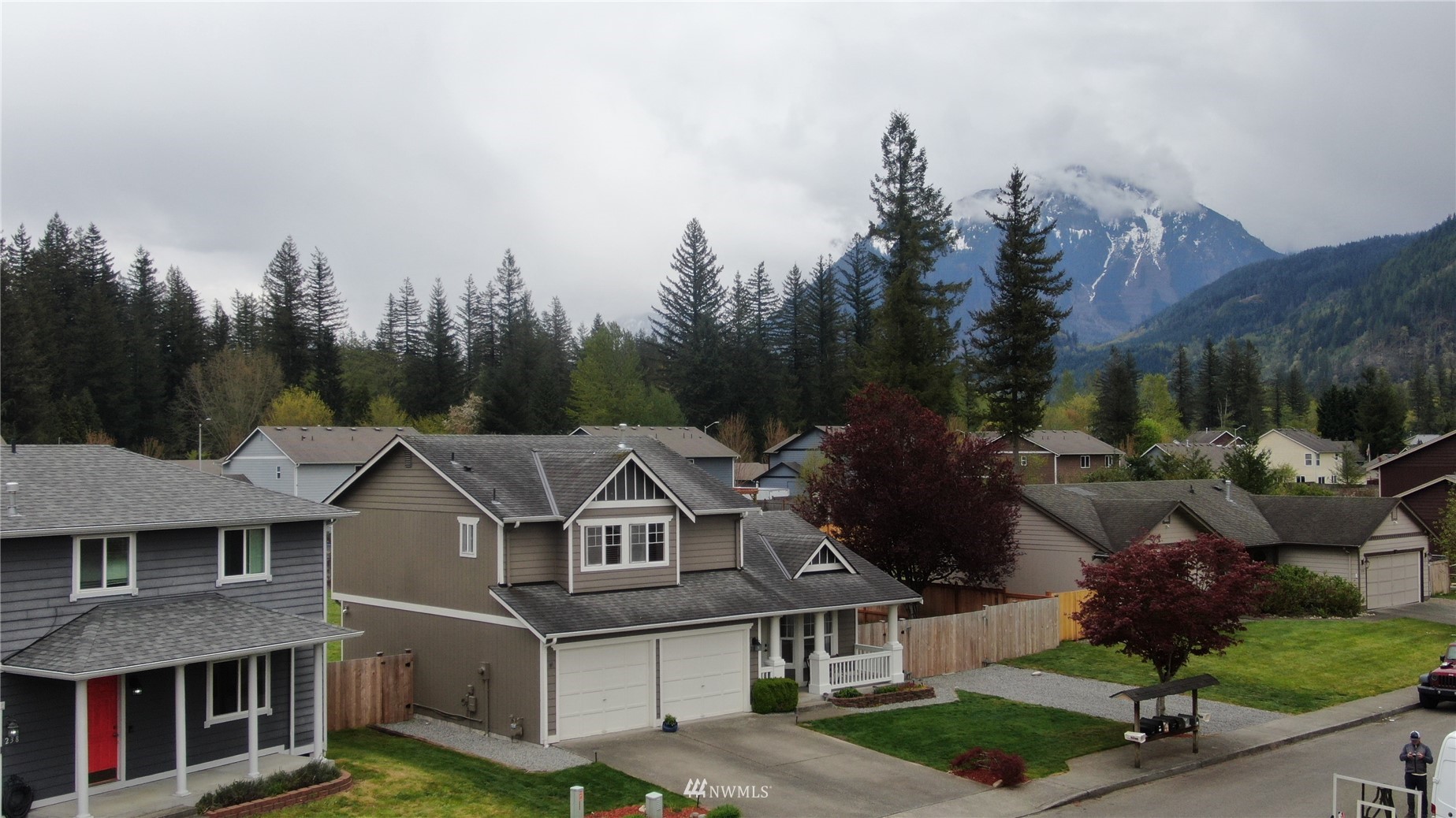234 17th Street Gold Bar, WA 98251 - Photo 25 of 25 a view of a white house next to a yard with large trees
