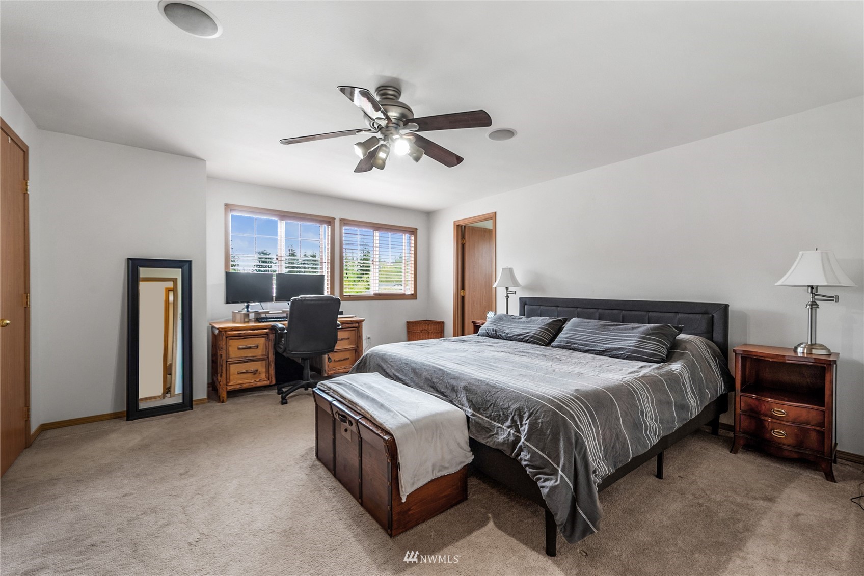 234 17th Street Gold Bar, WA 98251 - Photo 10 of 25 a spacious bedroom with a bed and a chandelier