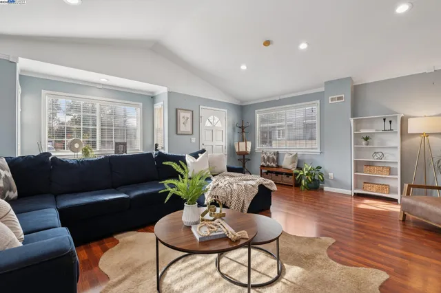 a living room with furniture and wooden floor