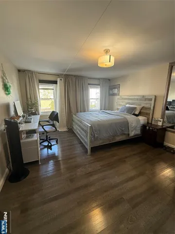 a bedroom with furniture and a wooden floor