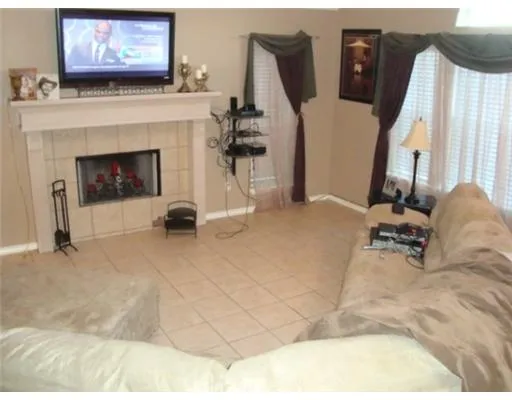 a view of hall way with furniture and fireplace