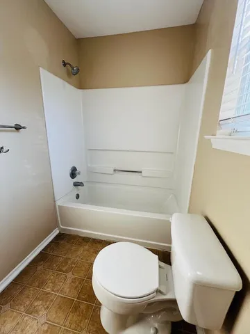 a bathroom with a toilet and a bathtub