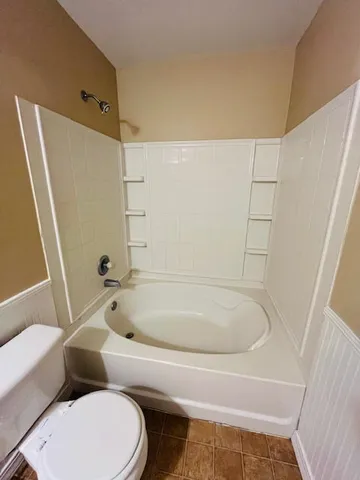 a bathroom with a bathtub and toilet
