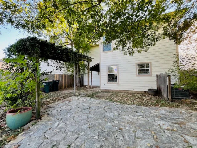 a view of a house with a tree in the background