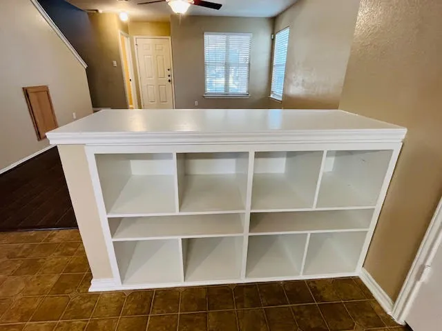 a room with a wooden floor and a large window
