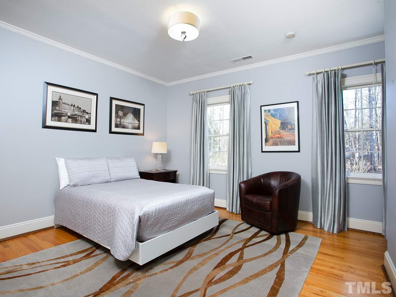 1528 Pinecrest Road Durham, NC 27705 - Photo 23 of 30 a bedroom with a bed and a chair