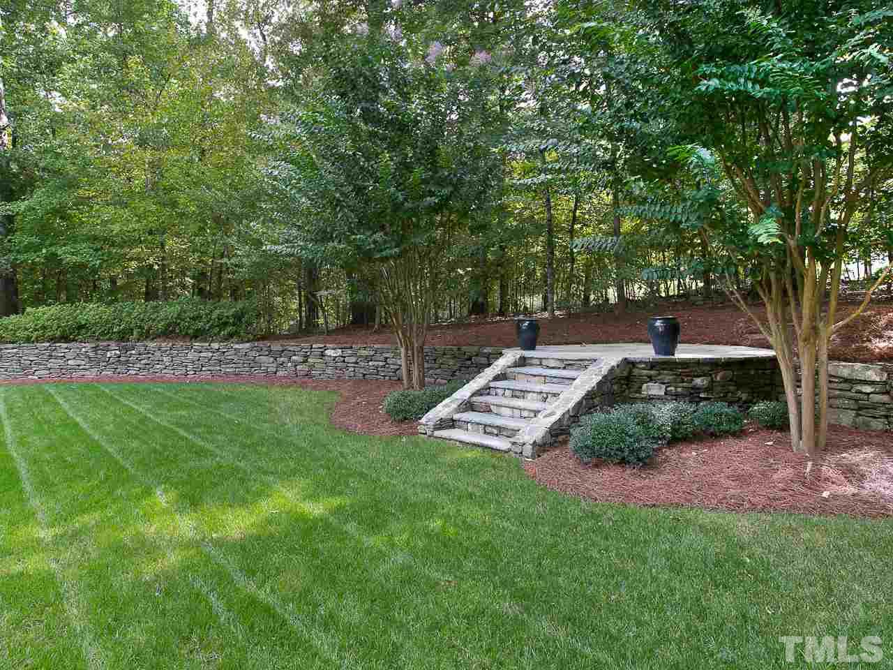 1528 Pinecrest Road Durham, NC 27705 - Photo 30 of 30 a garden with trees in front of it