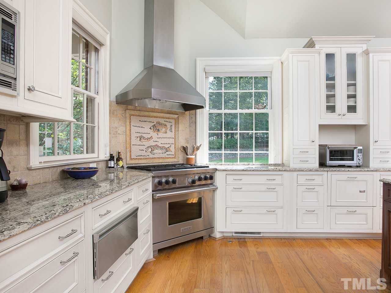 1528 Pinecrest Road Durham, NC 27705 - Photo 8 of 30 a kitchen with stainless steel appliances granite countertop a stove sink and cabinets