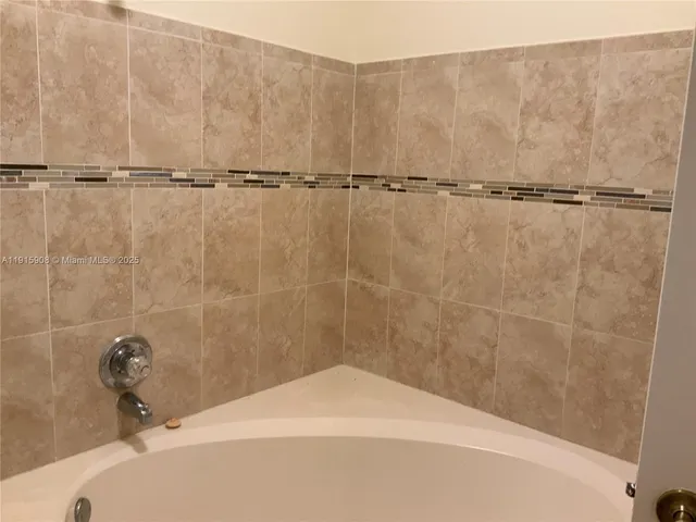 a bathroom with a toilet and shower