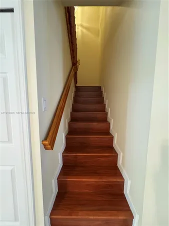 a bathroom with a bathtub shower sink mirror and toilet