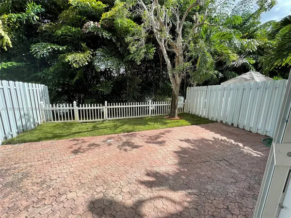 a view of a swimming pool with a porch and furniture