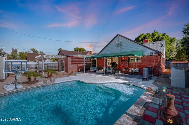 a view of a house with backyard porch and sitting area