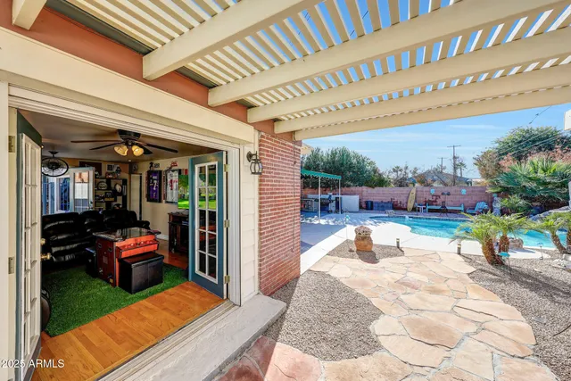 a view of a patio with a table and chairs under an umbrella with a patio