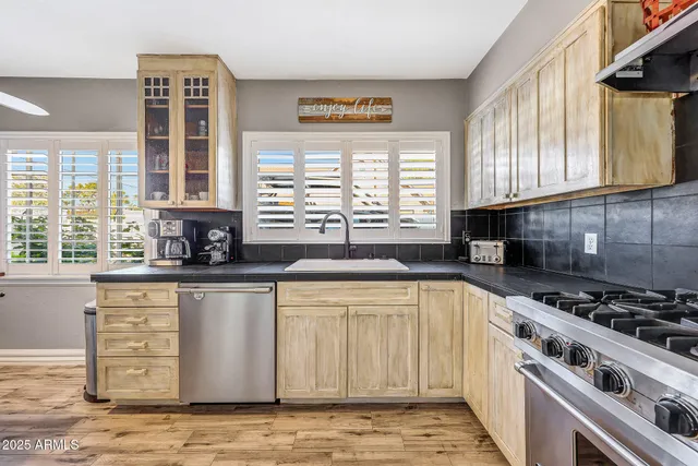 a kitchen with stainless steel appliances a stove a sink and a microwave