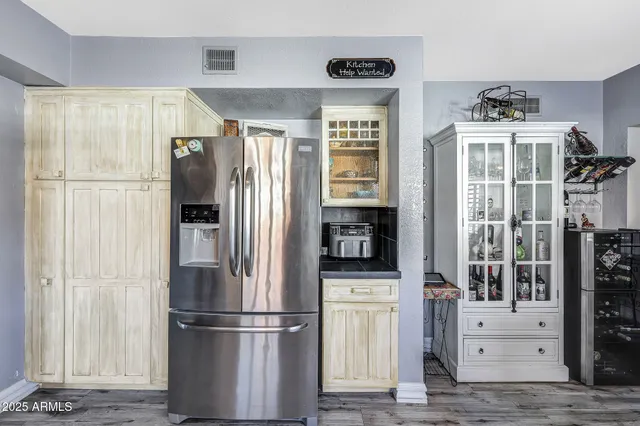 a kitchen with stainless steel appliances a refrigerator and a stove top oven