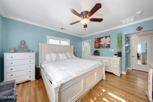 a spacious bedroom with a bed and a dresser