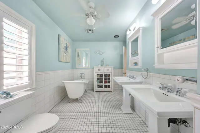 a bathroom with a double vanity sink mirror and toilet