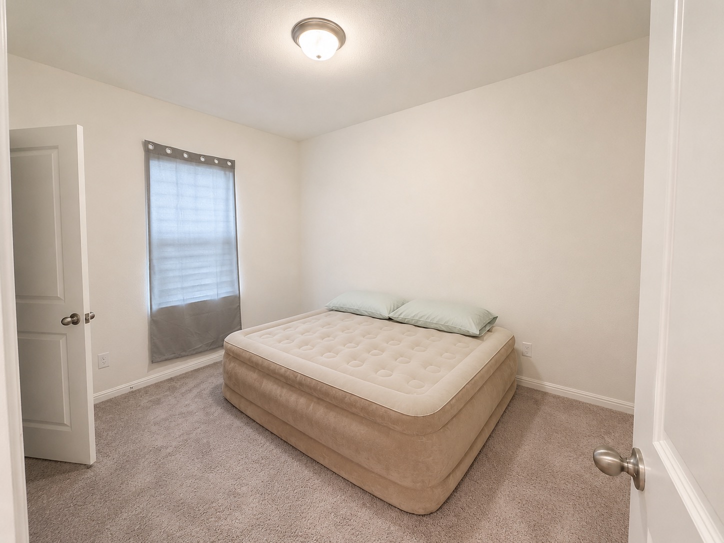 160 Light Timber Road Maxwell, TX 78656 - Photo 7 of 11 A well-lit bedroom features plush carpeting and a large window providing ample natural illumination.