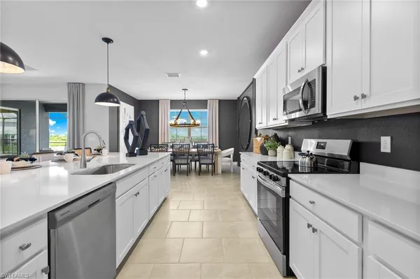 a kitchen with stainless steel appliances granite countertop a sink and cabinets