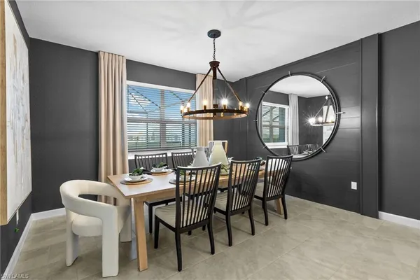 a dining room with furniture a rug and a chandelier