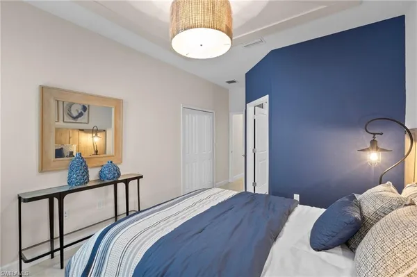 a bedroom with a bed and a chandelier