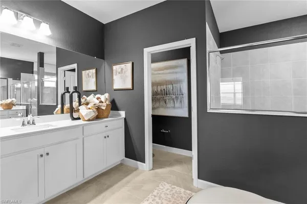 a en suite bathroom with a sink mirror and vanity