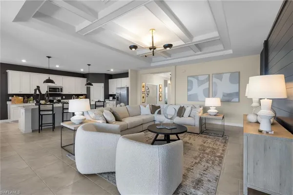 a living room with fireplace furniture and a chandelier