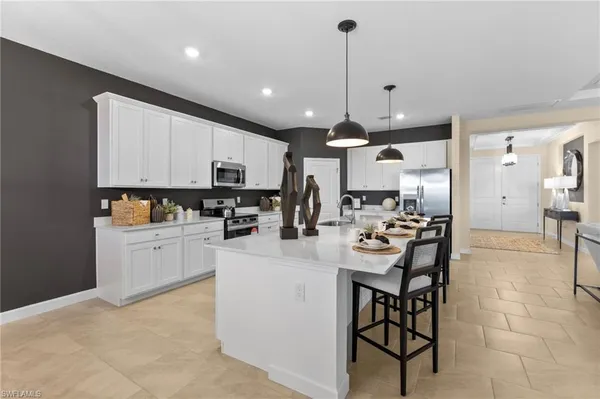 a kitchen with stainless steel appliances kitchen island granite countertop a sink and cabinets