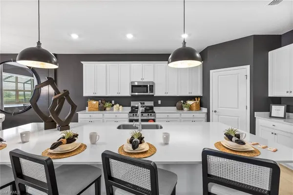 a kitchen with a refrigerator and a stove top oven