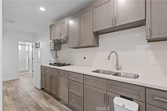a kitchen with stainless steel appliances a sink stove and cabinets