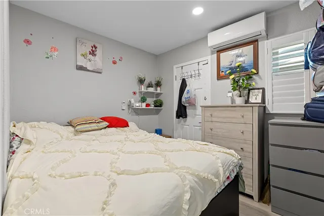 a bedroom with a bed and a dresser