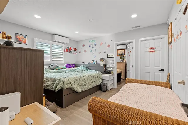 a bedroom with two beds and a dresser