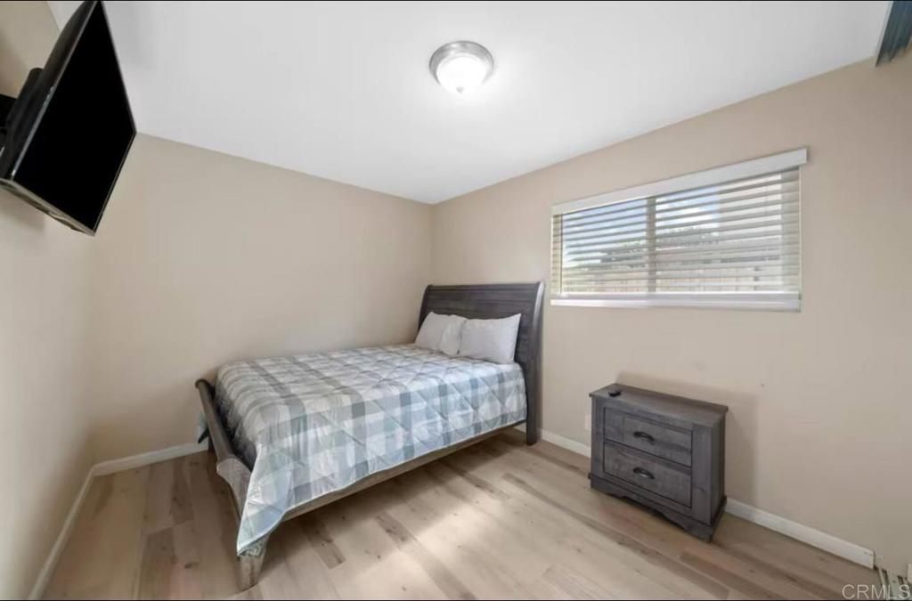 409 Pesca Court Spring Valley, CA 91977 - Photo 12 of 28 a bedroom with a bed and flat screen tv