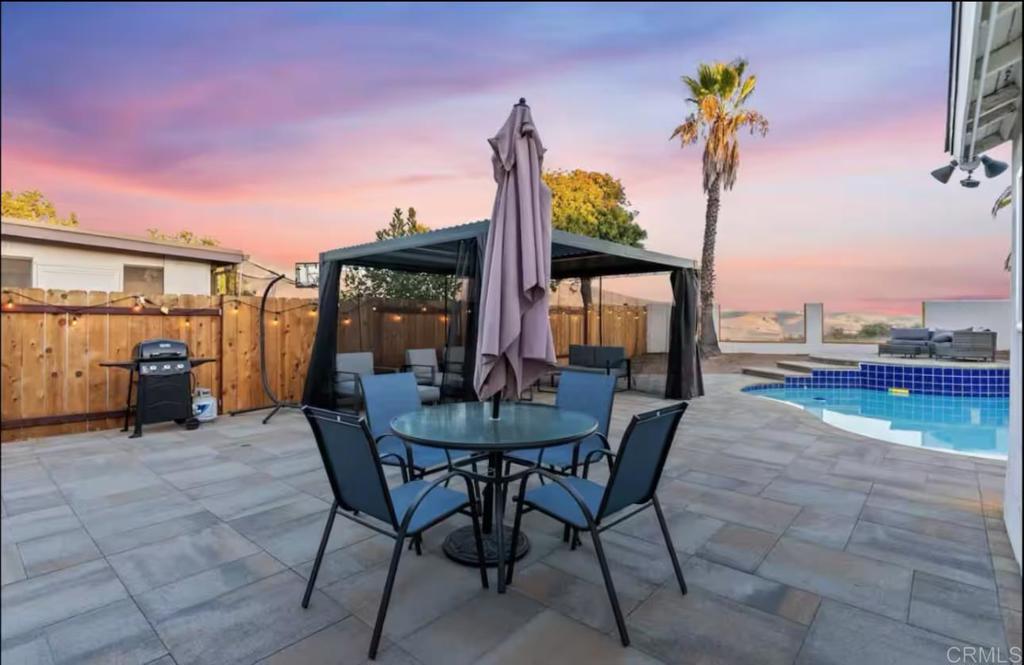 409 Pesca Court Spring Valley, CA 91977 - Photo 14 of 28 a view of a patio with a table and chairs