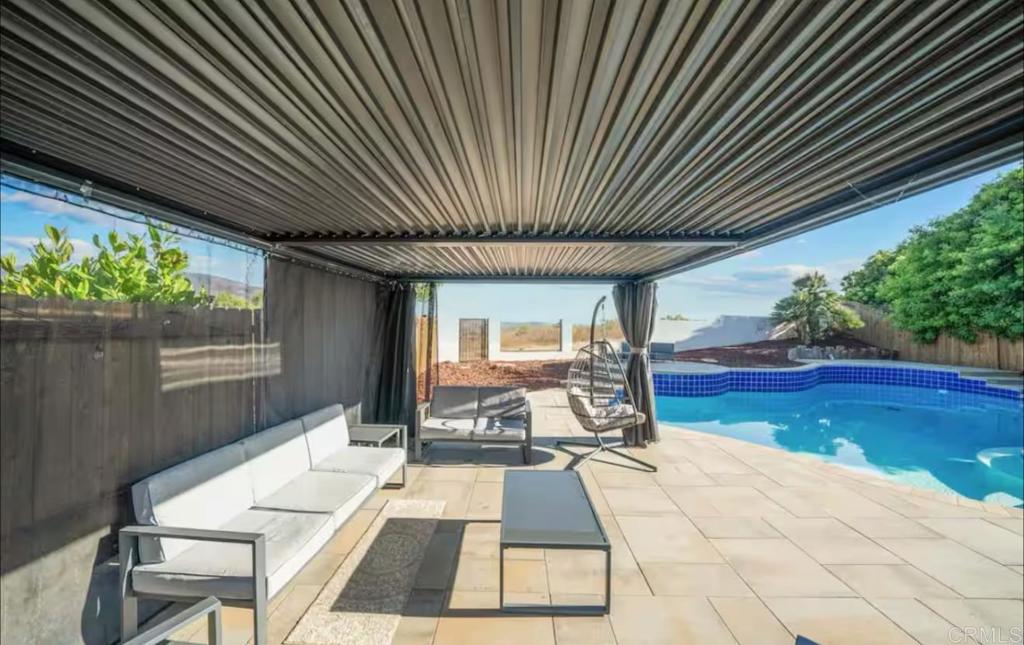 409 Pesca Court Spring Valley, CA 91977 - Photo 17 of 28 a view of swimming pool with seating space